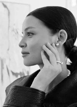Profile portrait in black and white, pear stud earring and a baguette ring
