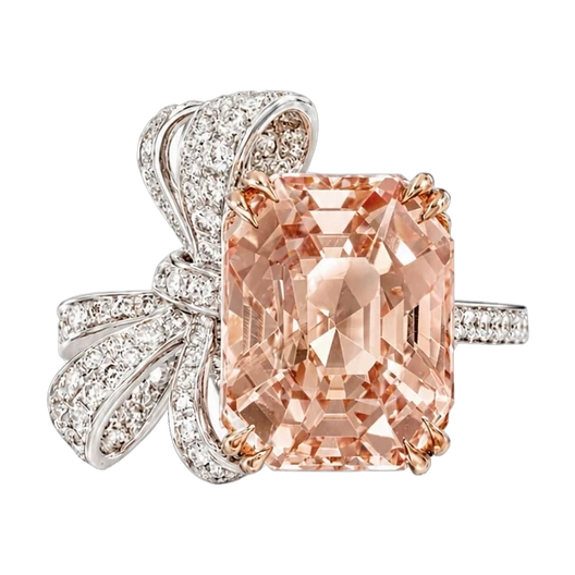 Emerald-cut peach sapphire ring with a pave diamond bow, in rose and white gold